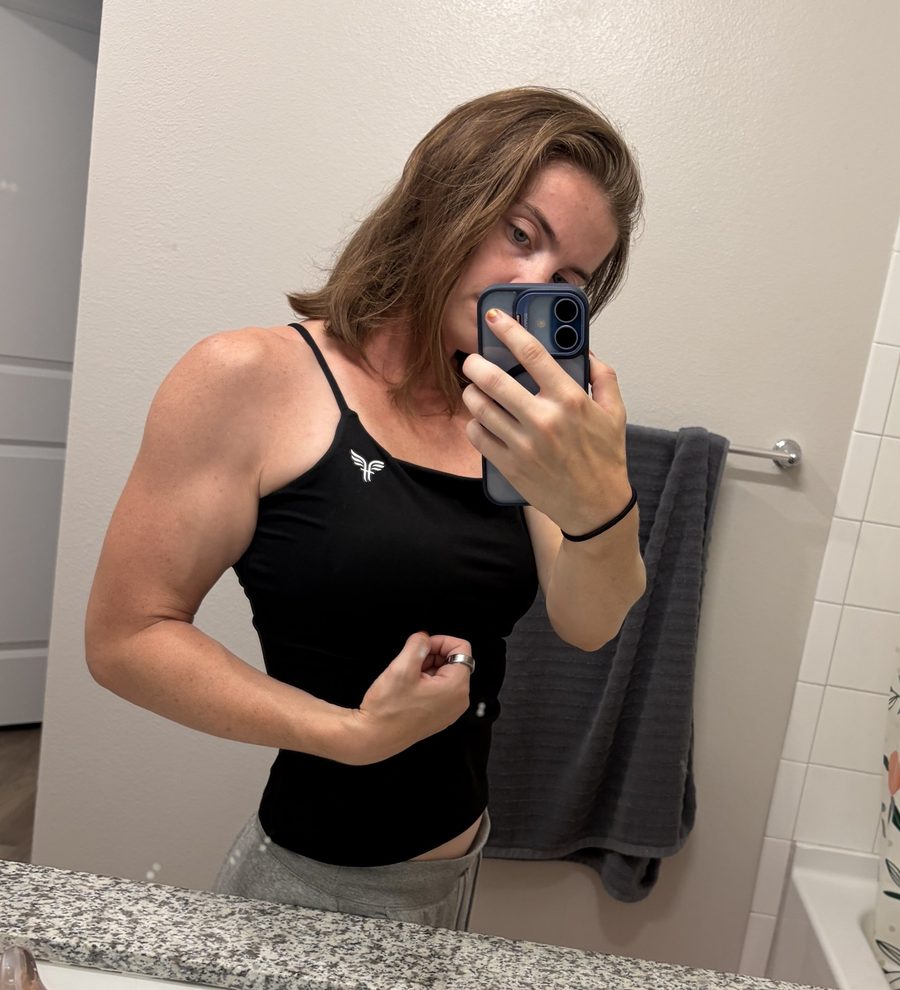 Coach Katie flexing in a mirror selfie